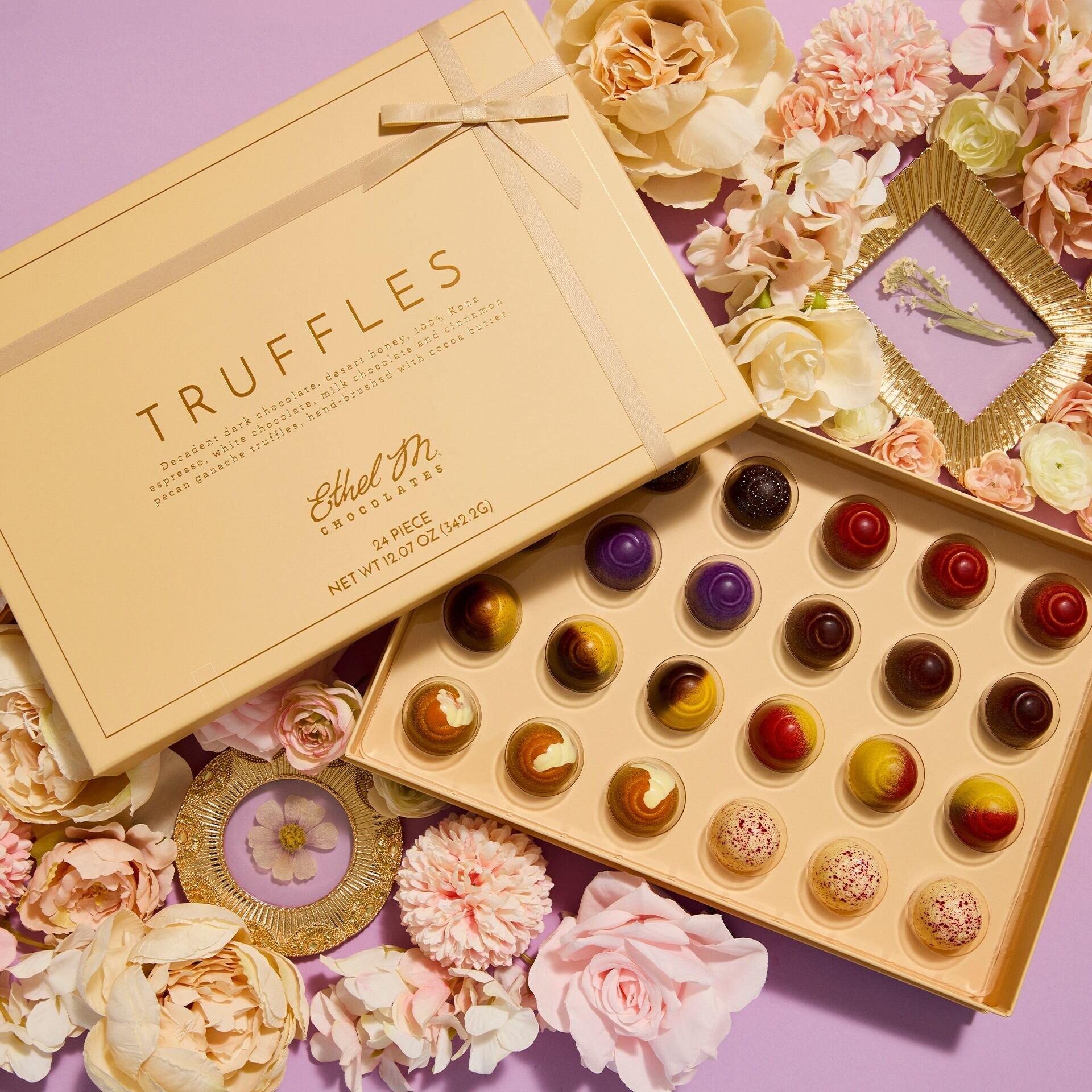Assortment of handcrafted chocolates in an elegant gift box, available for online purchase.